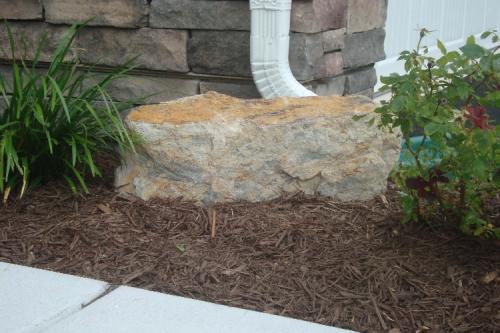 Boulder accents in flower bed (After)